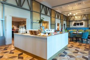 a restaurant with a counter with food on it at Park Inn by Radisson Antwerp City Centre in Antwerp