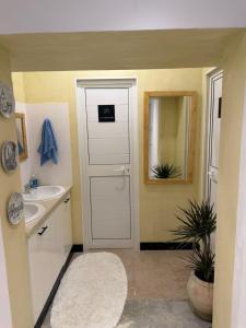 a bathroom with a white door and a sink at Nomads Hostel Sousse in Sousse +79 photos