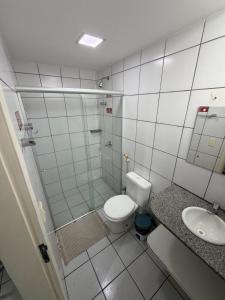 a bathroom with a shower and a toilet and a sink at Hotel Ideal in Teresina +23 photos