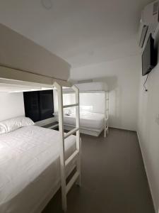a bedroom with two bunk beds and a tv at Finca Exclusiva en Carmen de Apicalá in Carmen de Apicalá +24 photos
