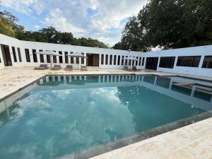 a swimming pool in front of a white building at Finca Exclusiva en Carmen de Apicalá in Carmen de Apicalá