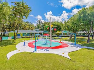 a playground in a park with a red white and blue at Coconut Bay Beach Resort & Spa All Inclusive in Vieux Fort