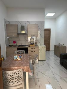 a kitchen with a table and chairs in a room at Binario104 in Naples