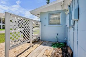 a blue house with a white gate next to a house at A Place in Paradise Unit B in Anna Maria