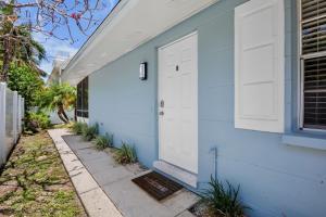 a blue house with a white door at A Place in Paradise Unit B in Anna Maria +26 photos