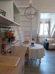 a kitchen and dining room with a table and a kitchen and a room at Beau duplex coeur historique et plages in Dives-sur-Mer