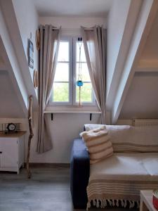 a room with a bed and a window at Beau duplex coeur historique et plages in Dives-sur-Mer +20 photos