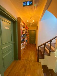 a hallway with a clock on the wall and a door at Just Datça in Datca