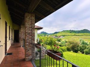 a balcony of a house with a view of the countryside at La Madonnina Agriturismo Dorè in Alba