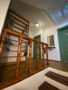 a staircase with wooden railings and a green door at Just Datça in Datca +42 photos
