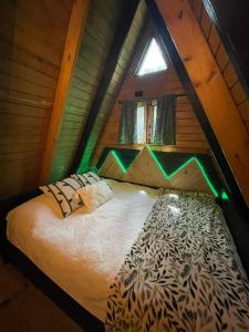 a bedroom with a bed in a attic at Hidden Cabins Puerto Rico in Comerio +56 photos