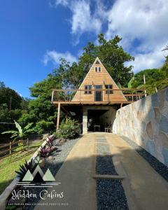 a house on top of a bridge with a building at Hidden Cabins Puerto Rico in Comerio