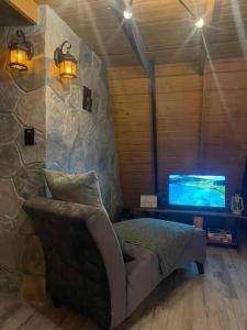 a bedroom with a bed and a tv in a room at Hidden Cabins Puerto Rico in Comerio