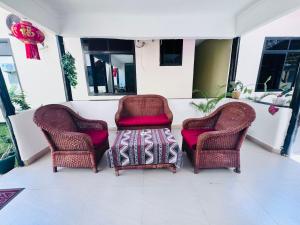 two chairs and a coffee table on a porch at Cactus Hotel in Dar es Salaam