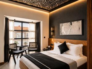 a hotel room with a bed and a window at The Local House Alaçatı in Alaçatı +60 photos