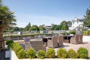 a patio with wicker chairs and a table in a courtyard at Belgrave Sands Hotel & Spa in Torquay