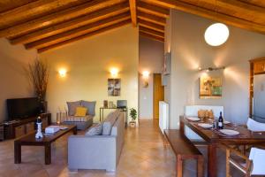 a living room with a couch and a table at Villa Caramel in Agios Ioannis