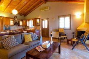 a living room with a couch and a table at Villa Caramel in Agios Ioannis