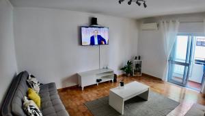 a living room with a couch and a table at Casa Inês in Fuzeta