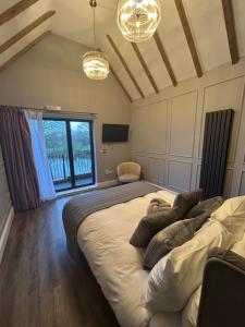 a bedroom with a large bed and a window at The Mill Sharnbrook - Bedford in Sharnbrook