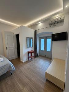 a bedroom with a bed and a table in it at Douskos Uptown Living in Hydra