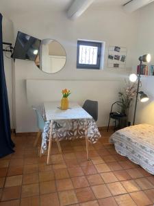 a room with a table and a mirror and a bed at La Maisonnette de Bédoin Mont Ventoux - Self Check In in Bédoin