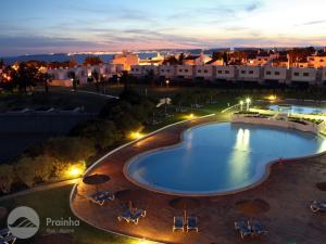 a view of a swimming pool at night at Prainha Clube in Alvor +93 photos