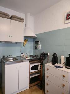a kitchen with a sink and a stove top oven at Chez Anna et Mat in Sérignan