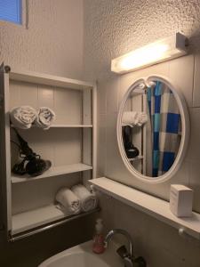 a bathroom with a sink and a mirror at Chez Anna et Mat in Sérignan +10 photos