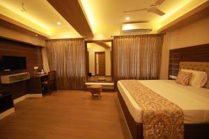 a hotel room with a bed and a desk at Fathima Residency in Pattanapuram