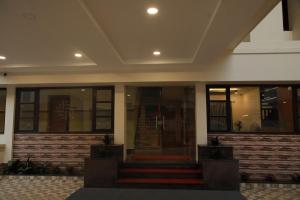 a lobby of a building with stairs and windows at Fathima Residency in Pattanapuram