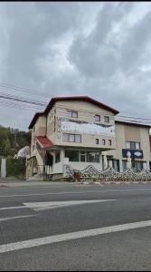 a large building on the side of a street at Coquette in Petrila