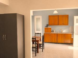 a kitchen with a table and a dining room at Ida Apartments in Sarandë