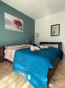 a bedroom with a bed with a blue comforter at Garda MarANDGi Home Salo' in Salò +49 photos