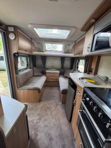 an interior view of an rv with a kitchen and a stove at Caravana dintre nuci in Oradea