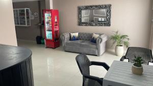 a living room with a couch and a table at Hotel Santo Rio Suite Santa Marta in Santa Marta