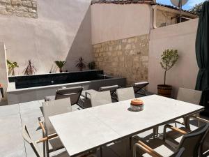 a white table and chairs on a patio at La pointe au sel in Aigues-Mortes
