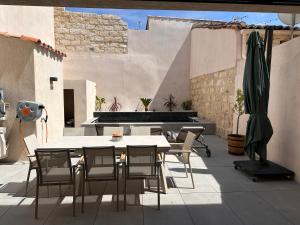 a patio with a table and chairs on a patio at La pointe au sel in Aigues-Mortes