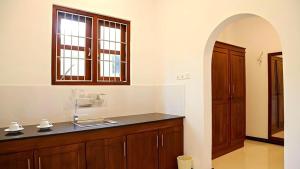 a kitchen with a sink and a counter with a window at Villa Estuary in Bentota