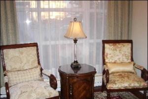 a room with two chairs and a table and a lamp at Hotel Phoenix in Reykjavík