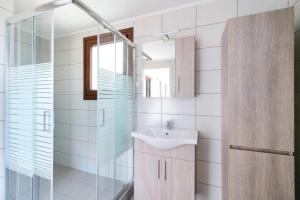 a bathroom with a sink and a mirror at Apanemia in Kallirákhi +17 photos