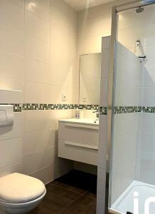 a bathroom with a toilet and a sink and a shower at Entre ciel et montagnes in Cauterets +10 photos
