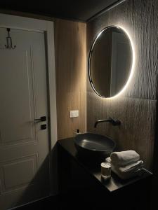 a bathroom with a sink and a mirror on the wall at Soho Apartment Fial in Bacău +6 photos