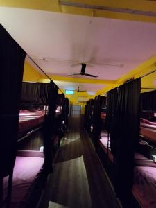 a hallway with beds in a room with a ceiling at Shri Ashray in Varanasi