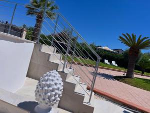 a set of stairs with a sculpture next to it at VILLA GIUDICE Luxury Home with Private Pool in Priolo Gargallo