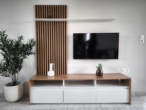 a living room with a tv on a wall at Aurelea Luxury Apartments in Kos