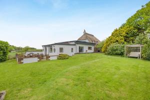 an image of a house with a yard at 6 Bed in Hersham oc-t29211 in Stratton