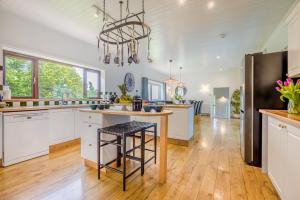 a kitchen with white cabinets and a black refrigerator at 6 Bed in Hersham oc-t29211 in Stratton