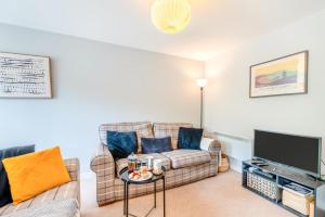 a living room with two couches and a tv at 3 Bed in Tenby oc-93359 in Redberth