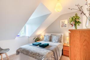 a bedroom with a bed with blue pillows on it at 3 Bed in Tenby oc-93359 in Redberth